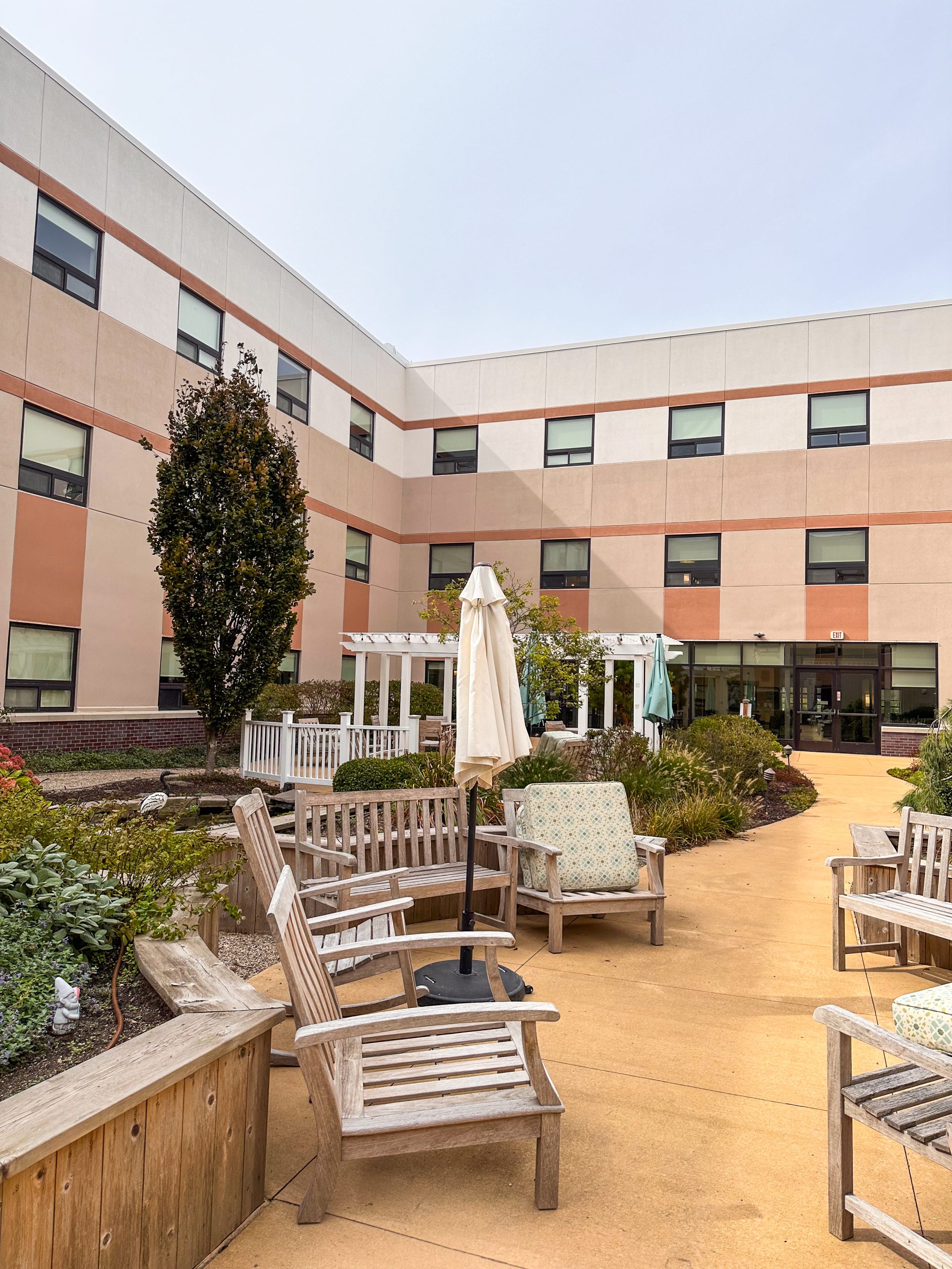 Wide angle view of completed senior living courtyard with freshly painted EIFS exterior in Wyoming Michigan