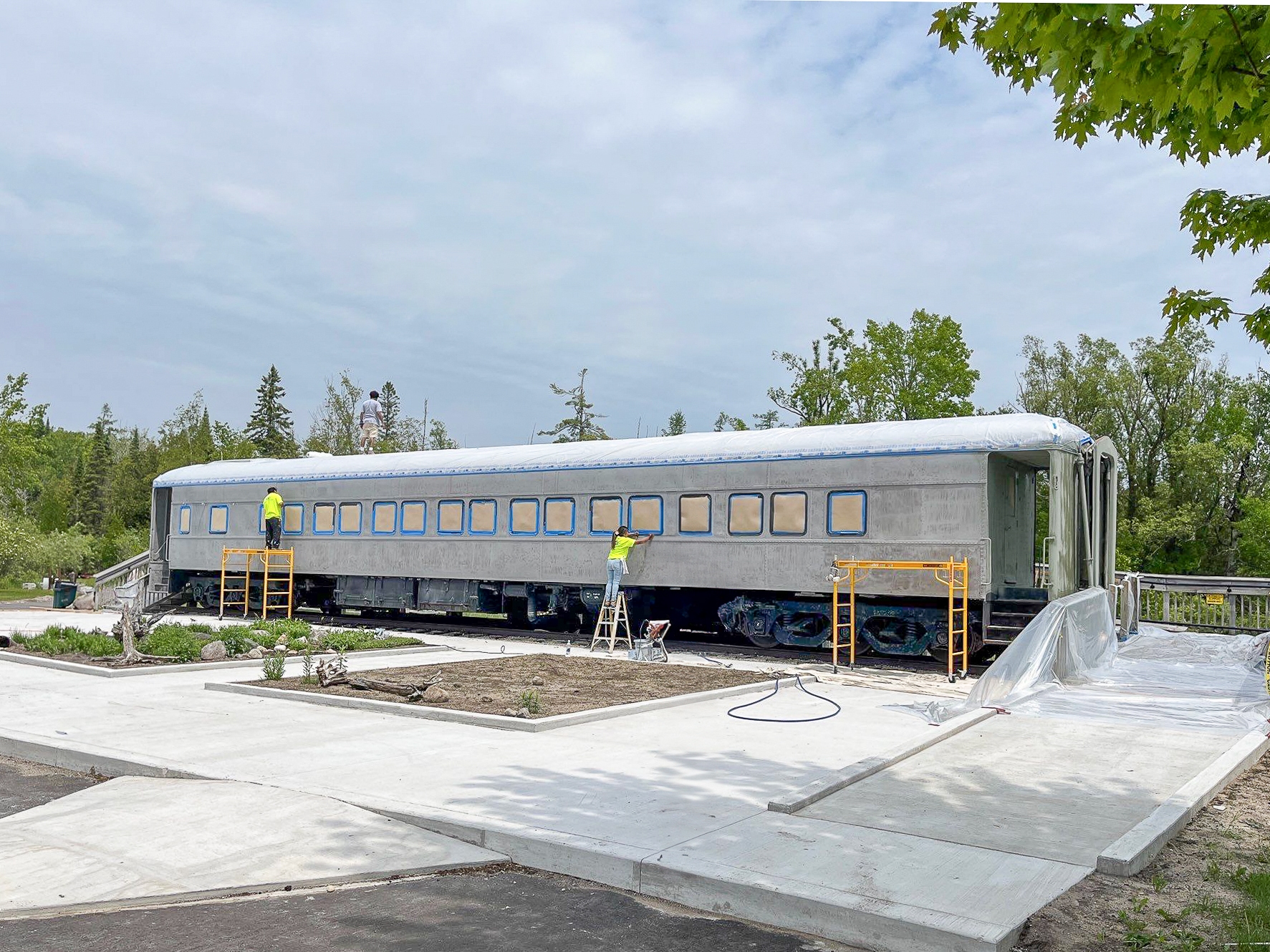 Railcar undergoing a sandblasting application in preparation for industrial coating application.