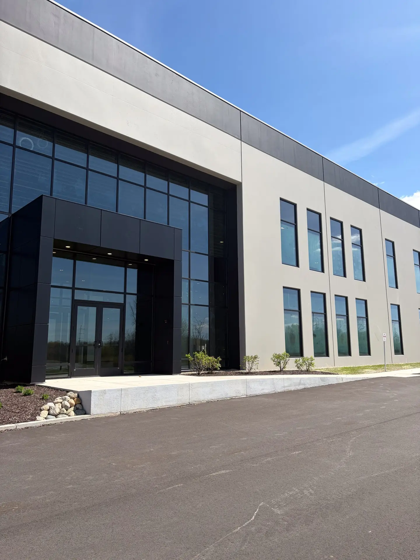 Exterior tilt-up concrete warehouse with two-tone coating system using Loxon self-cleaning acrylic