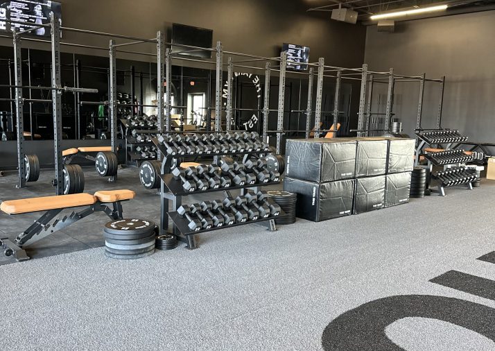 Wide-angle shot of The Yard Gym Grand Haven showcasing durable, high-quality commercial painting on walls and ceilings, enhancing the gym's aesthetic and functionality.